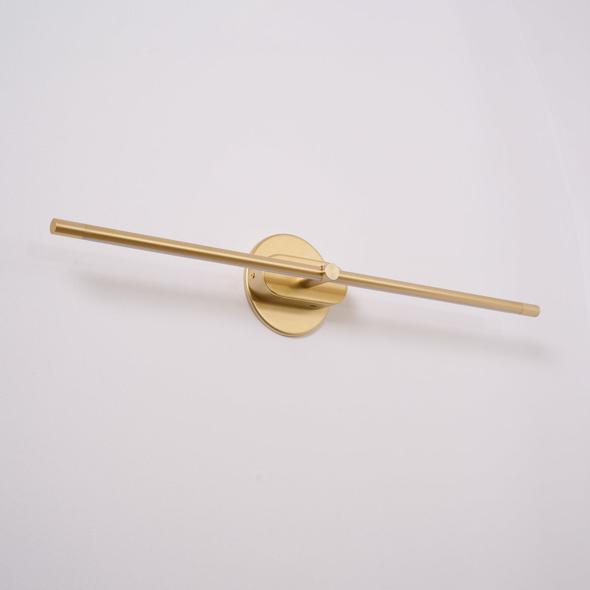 Lumiris modern linear wall light in black and gold, warm lighting.