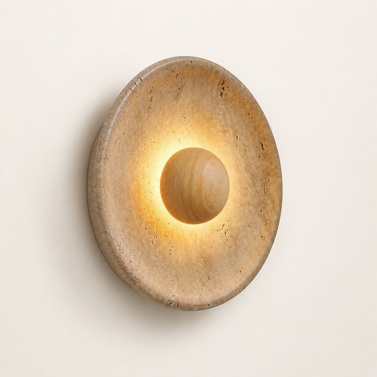 Lumiris sculptural wall light in travertine and wood, warm light diffused around a central sphere.