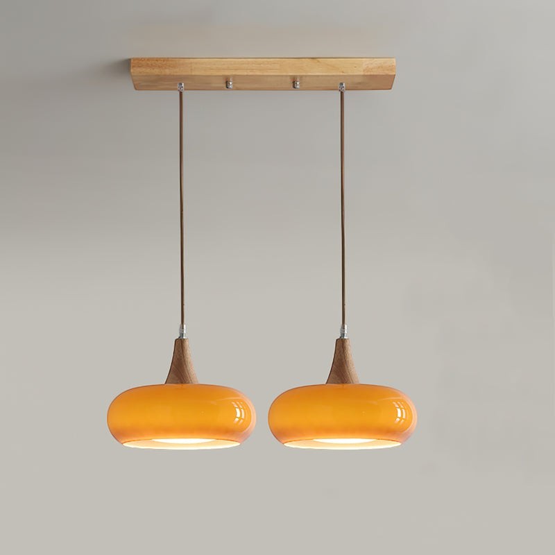 Lumiris 2-shade amber glass and wood pendant light, modern style, warm ambient light.