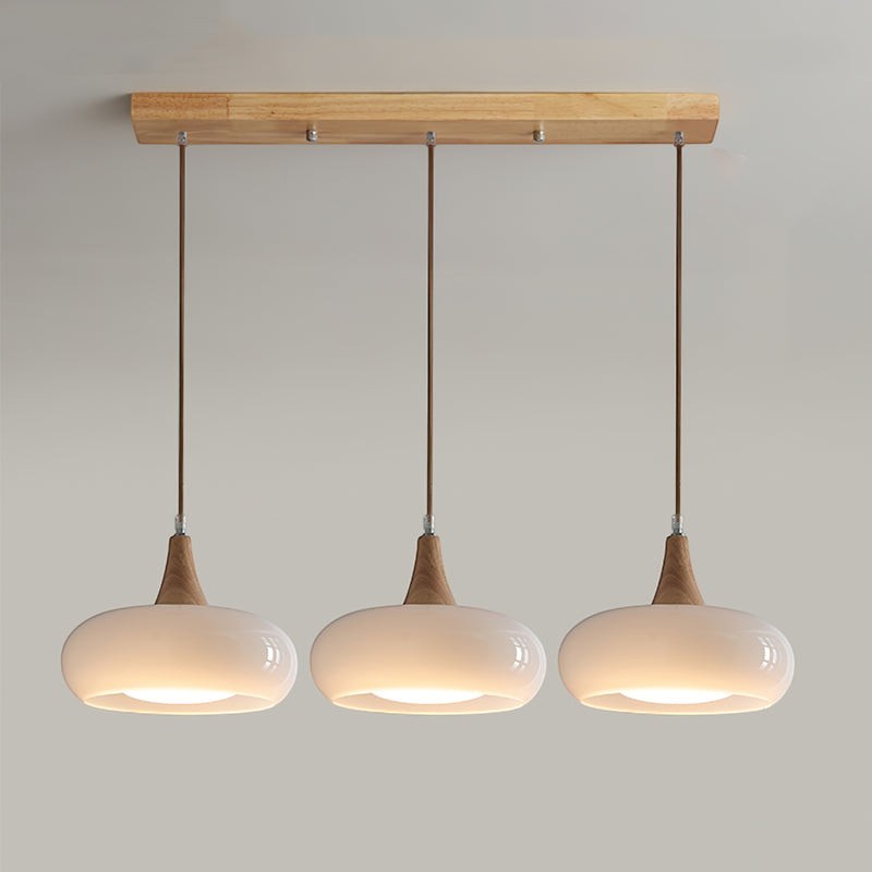 Lumiris wood and milky white glass pendant light, 3 oval shades, modern design for a kitchen or dining room.