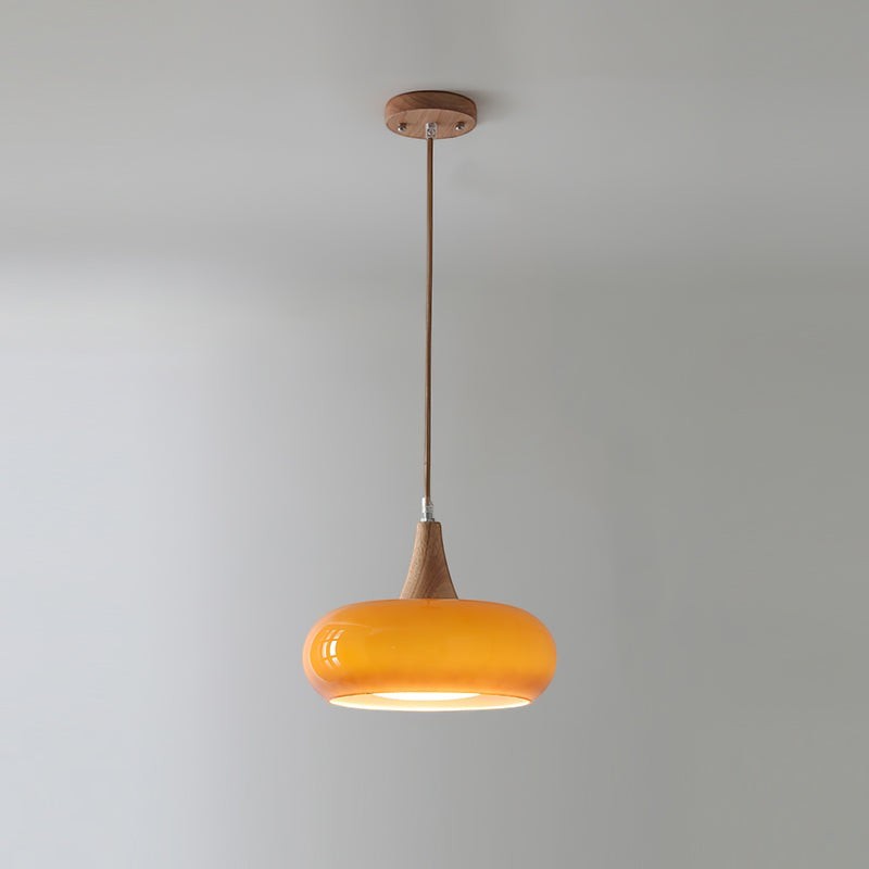 Lumiris amber glass and wood pendant light, modern design, round shade, warm lighting.